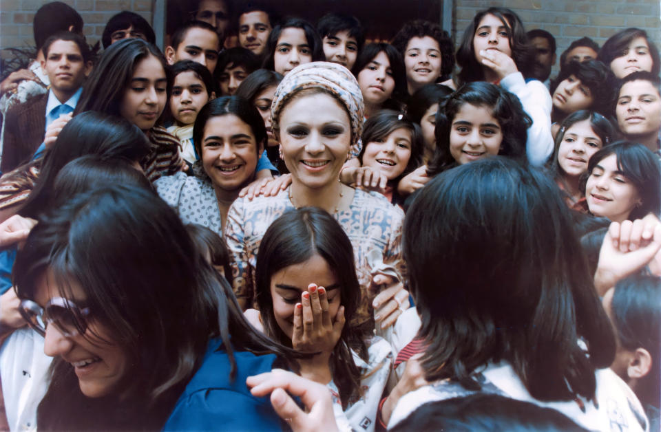 HIM Farah Pahlavi with a group of school children in Iran