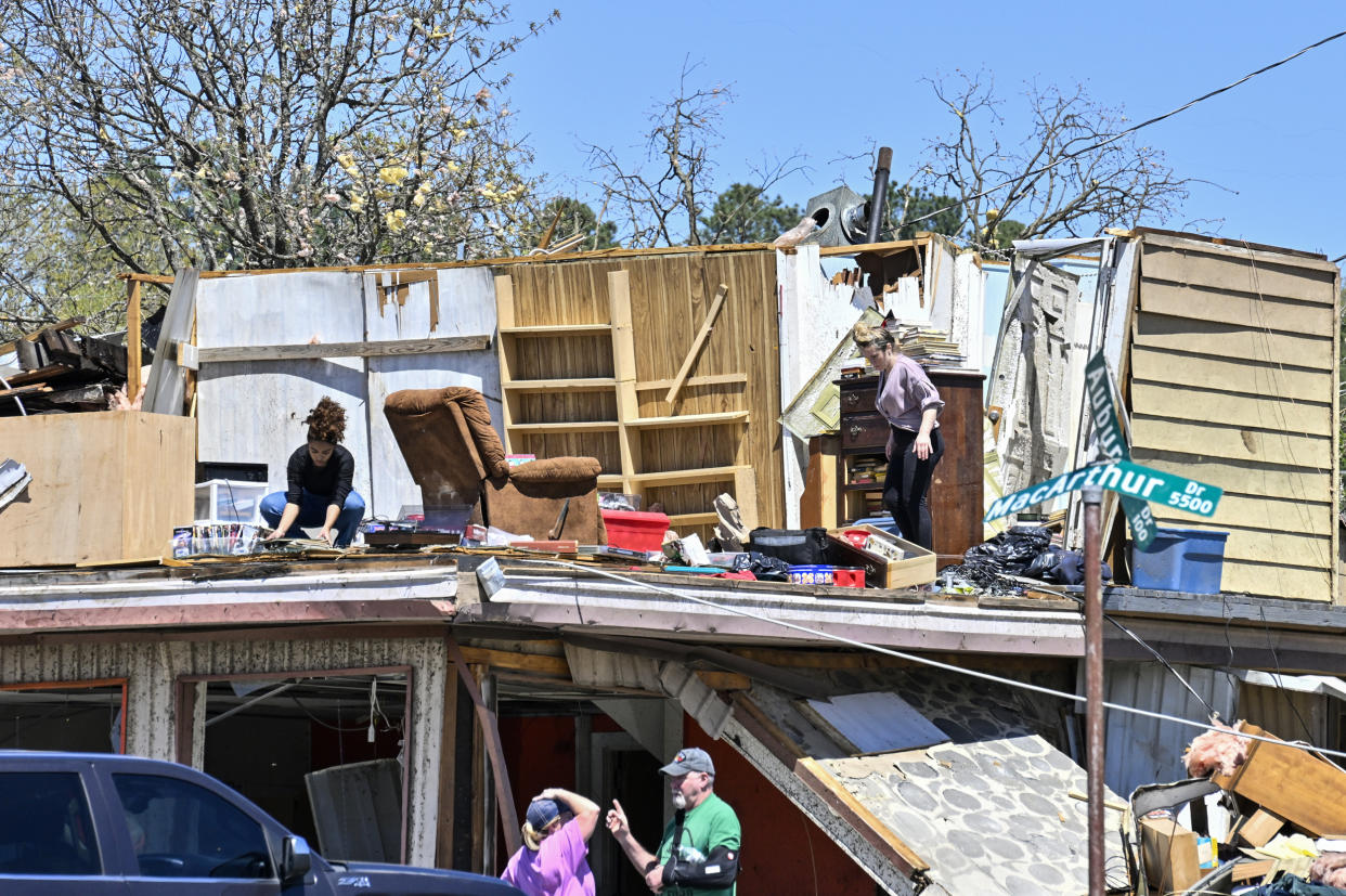 People clean up after the devastating tornadoes in Little Rock, Ark., on April 1, 2023. (Peter Zay / Anadolu Agency via Getty Images)