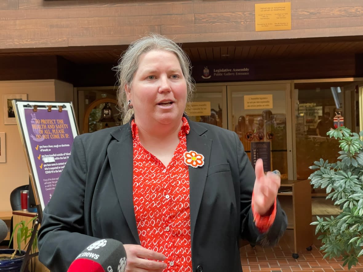 NDP Leader Kate White scrumming with reporters after the first sitting of the Legislative Assembly in May. She said some protestors went too far after the final sitting of the Legislature on Thursday, when they yelled, swore and spat on her car as she was trying to leave. (Wayne Vallevand/ CBC - image credit)