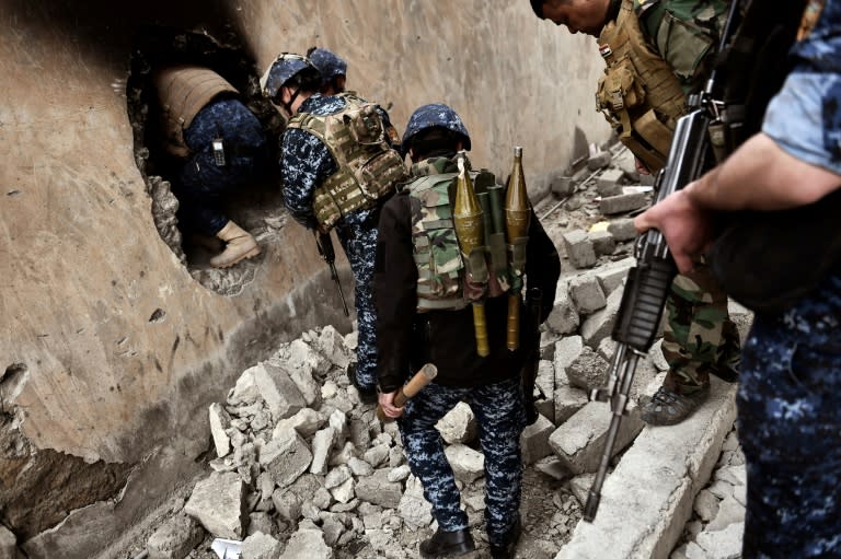 Members of the Iraqi forces advance towards the Old City in western Mosul on March 13, 2017