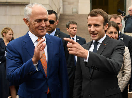 French President Emmanuel Macron (R) gestures as he stands next to Australian Prime Minister Malcolm Turnbull after a Commemorative Service at the Anzac war memorial in Sydney, May 2, 2018. AAP/David Moir/via REUTERS