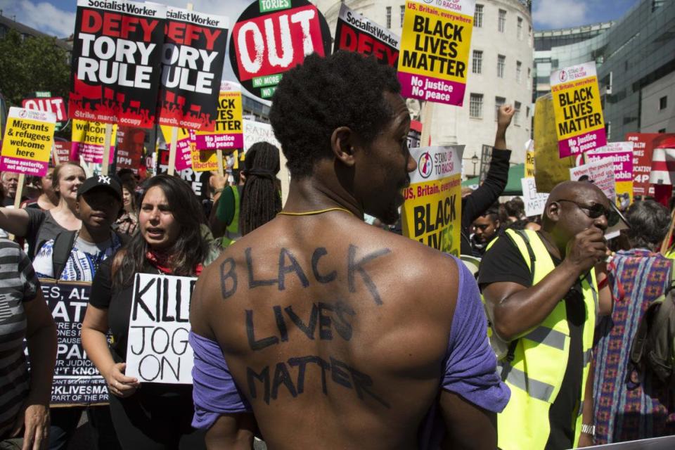 <div class="inline-image__caption"><p>Black Lives Matter supporters at the Peoples Assembly demonstration: No More Austerity - No To Racism - Tories Must Go, July 16, 2013 in London. Tens of thousands of people gathered to protest in a march through the capital protesting against the Conservative Party cuts. Almost 150 Councillors from across the country have signed a letter criticizing the Government for funding cuts and and will be joining those marching in London. The letter followed the recent budget in which the Government laid out plans to cut support for disabled people while offering tax breaks for big business and the wealthy.</p></div> <div class="inline-image__credit">Mike Kemp/Getty</div>