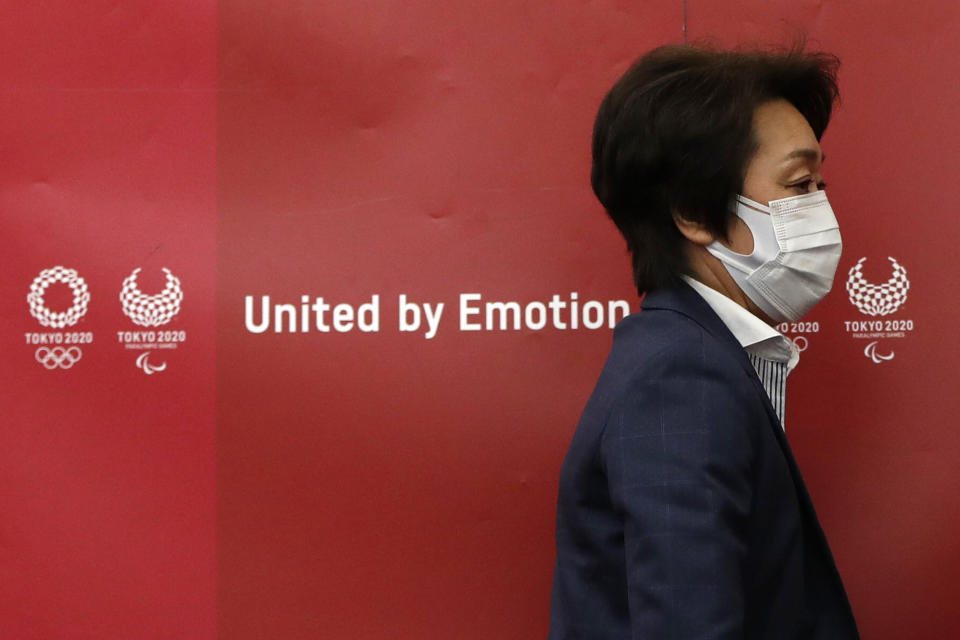 Tokyo 2020 Olympics Organizing Committee President Seiko Hashimoto leaves a news conference after a meeting with local municipalities working group hosted by the government in Tokyo Wednesday, June 23, 2021, on the day to mark one month to go until the opening of the Olympic Games. (Issei Kato/Pool Photo via AP)