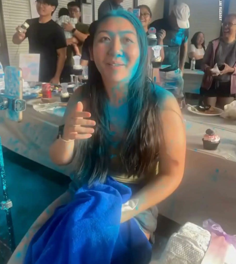 Despite being covered in blue powder, Lila Wong laughed off the messy mistake and celebrated the special occasion with the rest of the party. FOX 8