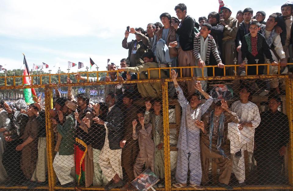 FILE - In this file photo taken on Sunday, March 30, 2014, Supporters of Afghanistan's presidential candidate and former foreign minister Zalmai Rassoul, listen to his speech during his campaign rally in Herat, Afghanistan. (AP Photo/Massoud Hossaini, File)