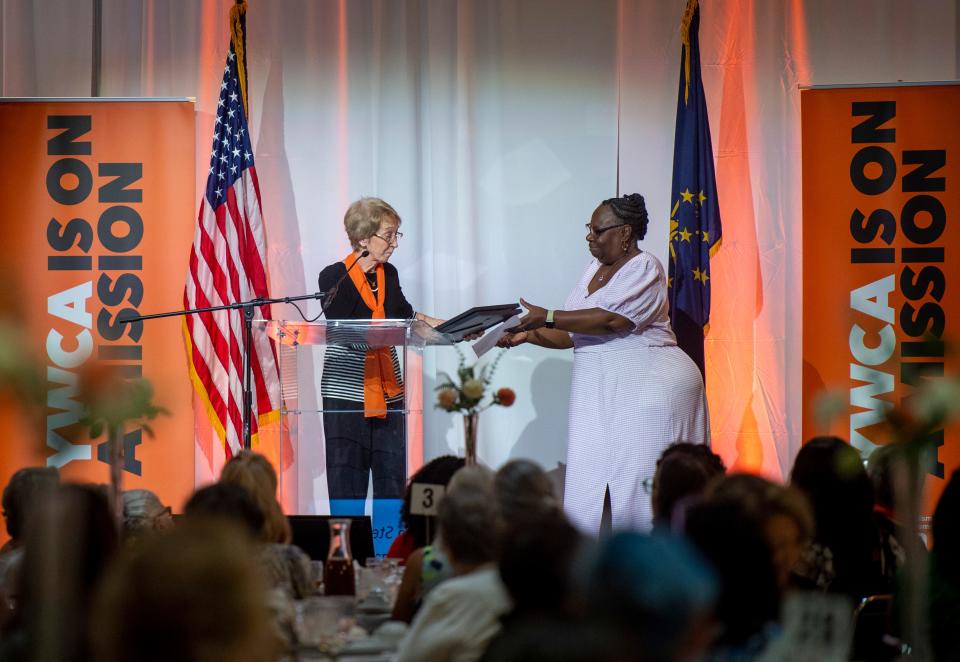 Lana Burton, right, accepts the legacy award honoring Sally Wyatt Stewart on behalf of the Evansville African American Museum at the 2023 YWCA Women’s Equality Day Luncheon at Old National Events Plaza in Evansville, Ind., Thursday, Aug. 24, 2023.