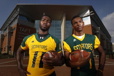 Adolphus Washington (left) and Dwayne Stanford in front of Taft High School in July 2011.