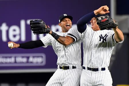 Oct 18, 2017; Bronx, NY, USA; New York Yankees center fielder Aaron Hicks (31) and right fielder Aaron Judge (99) celebrates after beating the Houston Astros in game five of the 2017 ALCS playoff baseball series at Yankee Stadium. Mandatory Credit: Robert Deutsch-USA TODAY Sports