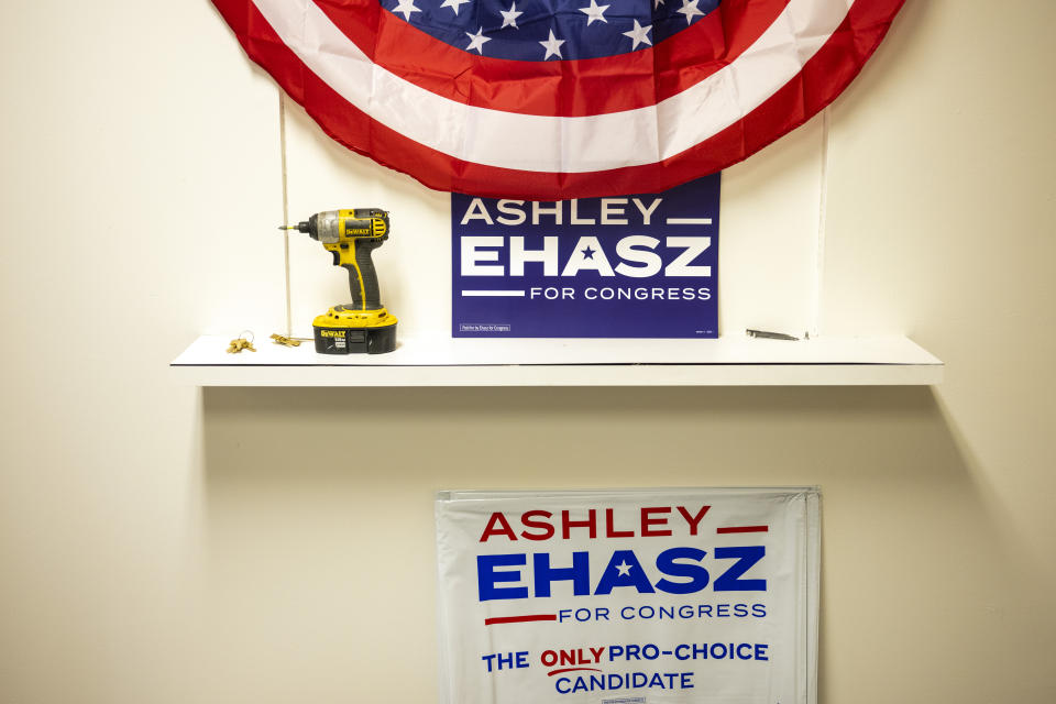 Signs are displayed at Ashley Ehasz' campaign headquarters, Tuesday, June 4, 2024, in Bristol, Pa. (AP Photo/Joe Lamberti)