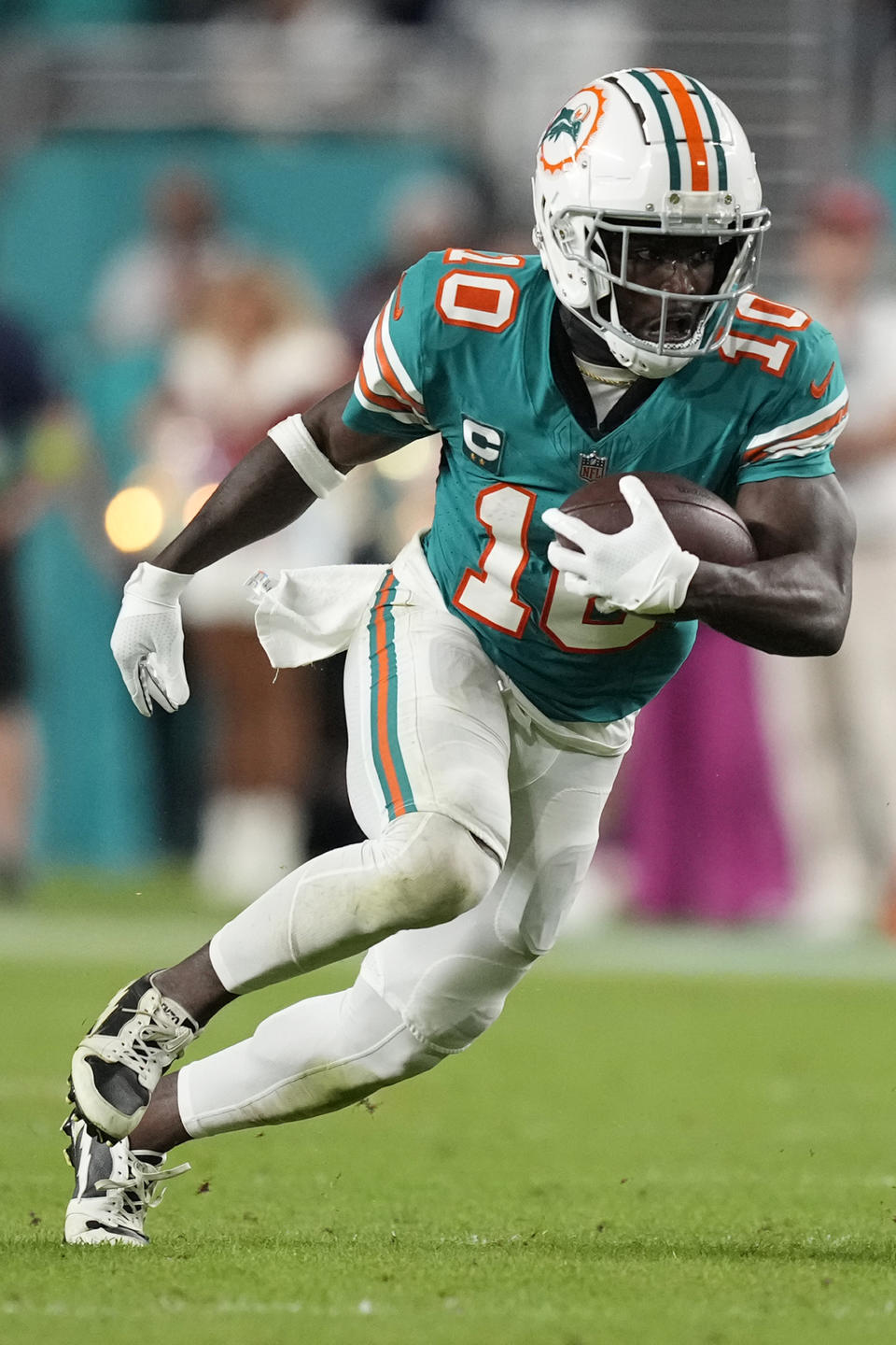 Miami Dolphins wide receiver Tyreek Hill (10) runs with the football during the second half of an NFL football game against the Dallas Cowboys, Sunday, Dec. 24, 2023, in Miami Gardens, Fla. (AP Photo/Rebecca Blackwell)