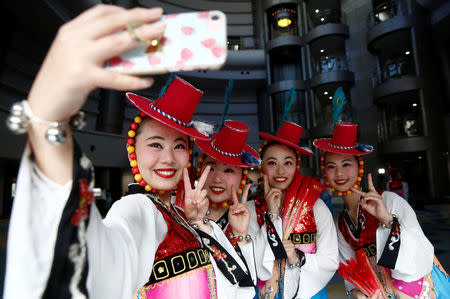 High school students from a dance club at Kanagawa Korean Middle and High School take a selfie after their traditional dance performance at a local international day event to promote a multicultural society in Yokohama, Kanagawa Prefecture, Japan,May 20, 2018. REUTERS/Kim Kyung-Hoon