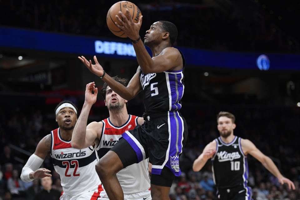 Sacramento Kings guard De'Aaron Fox scores over Washington Wizards forward Dani Avdija during the second half of an NBA basketball game Thursday, March 21, 2024, in Washington. (AP Photo/John McDonnell)