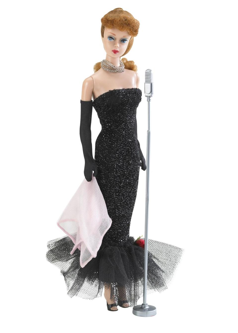 <p>With her strapless black dress and long gloves, Barbie Solo In The Spotlight becomes one of the more glamorous dolls ever. </p><p><a href="http://www.goodhousekeeping.com/life/g2530/barbie-dolls-history-facts/" rel="nofollow noopener" target="_blank" data-ylk="slk:18 things you didn't know about Barbie »;elm:context_link;itc:0;sec:content-canvas" class="link "><em>18 things you didn't know about Barbie »</em></a></p>