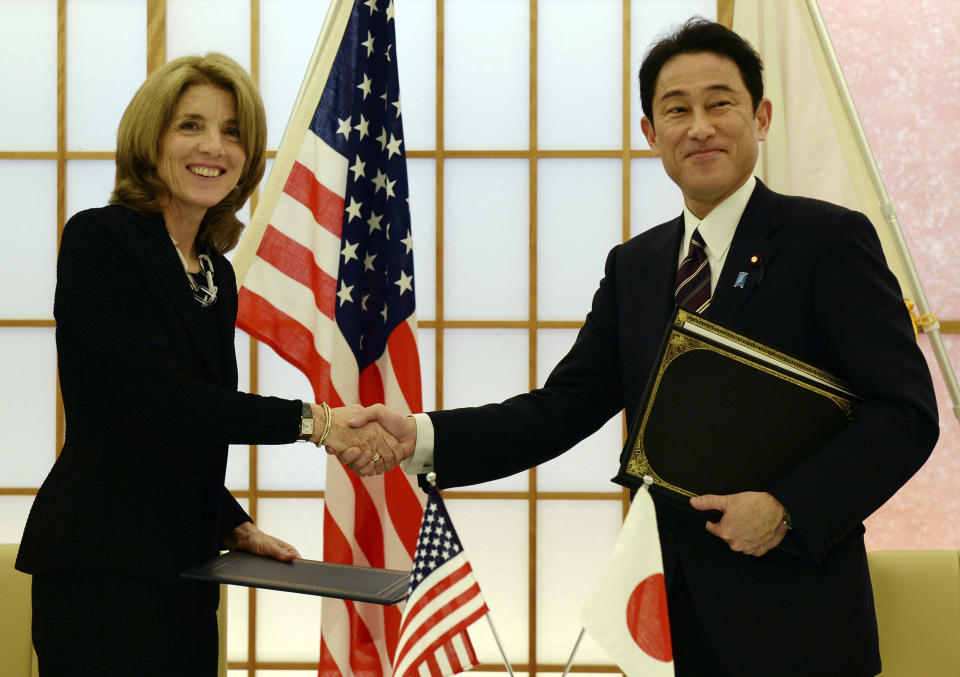 FILE - In this April 23, 2014, file photo, U.S. Ambassador to Japan Caroline Kennedy, left, shakes hands with Japanese Foreign Minister Fumio Kishida after exchanging the documents to extend the agreement on cooperation in research and development in science and technology between the two countries in Tokyo. Kennedy is stepping down Wednesday, Jan. 18, 2017 after three years as U.S. ambassador to Japan, where she was welcomed like a celebrity and worked to deepen the U.S.-Japan relationship despite regular flare-ups over American military bases on the southern island of Okinawa. (Toshifumi Kitamura/Pool Photo via AP, File)