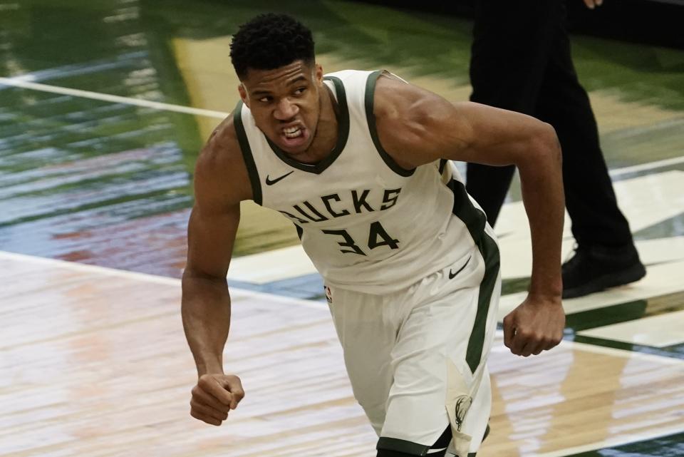 Milwaukee Bucks' Giannis Antetokounmpo reacts after his dunk during the first half of an NBA basketball game Tuesday, Feb. 23, 2021, in Milwaukee. (AP Photo/Morry Gash)