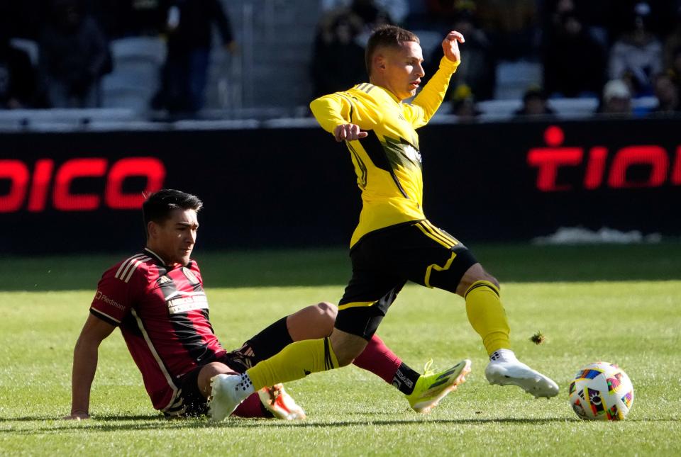 Feb 24, 2024; Columbus, OH, USA; Columbus Crew midfielder Alexandru Măţan (20) pulls the ball around Atlanta United forward Tyler Wolff (28) at Lower.com Field. Mandatory Credit: