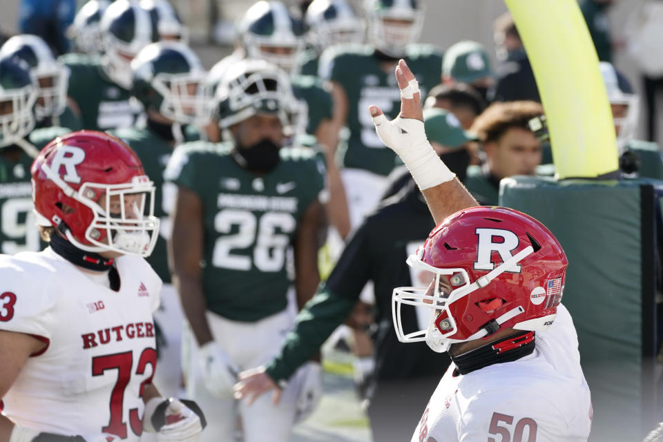 Rutgers offensive lineman Cj Hanson (50) looks towards his family after Rutgers defeated Michigan State in an NCAA college football game, Saturday, Oct. 24, 2020, in East Lansing, Mich. (AP Photo/Carlos Osorio)