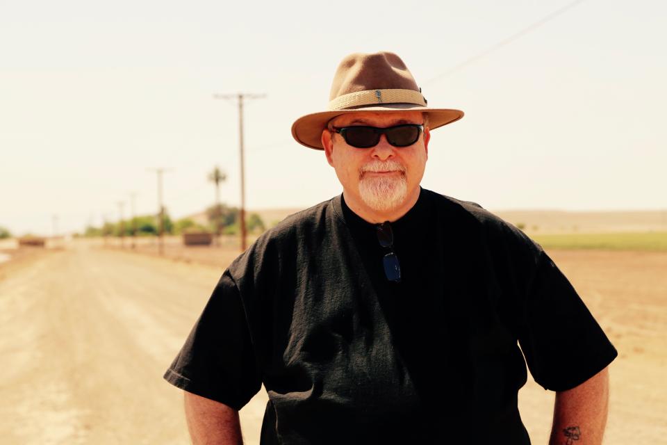 John Grasson stands at a dirt road intersection in Imperial, Calif., where he believes the lost ship of the desert may be buried.