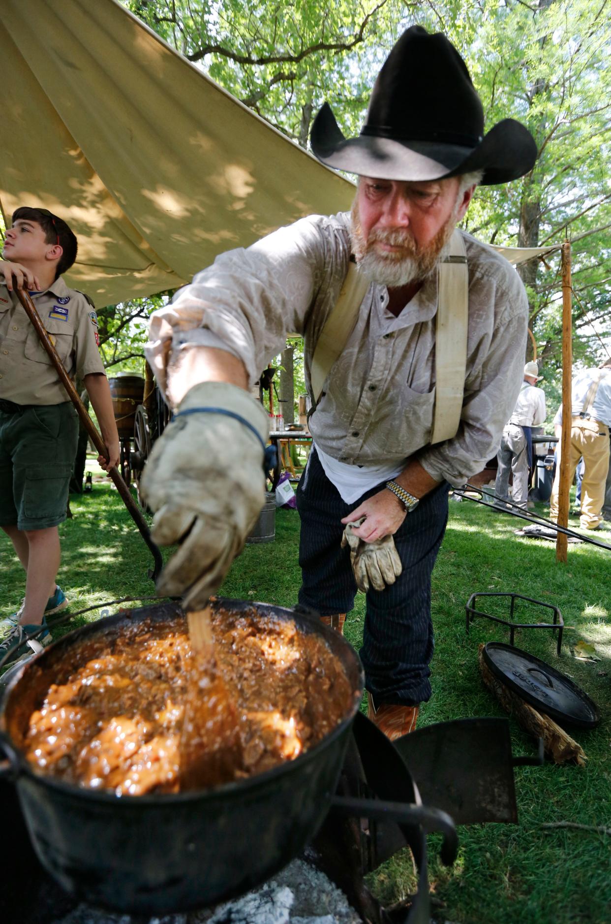 Adam Emerson cooks a large batch of barbecue beef stew during the 27th annual Chuck Wagon Festival at the National Cowboy & Western Heritage Museum in Oklahoma City, which returns this weekend.