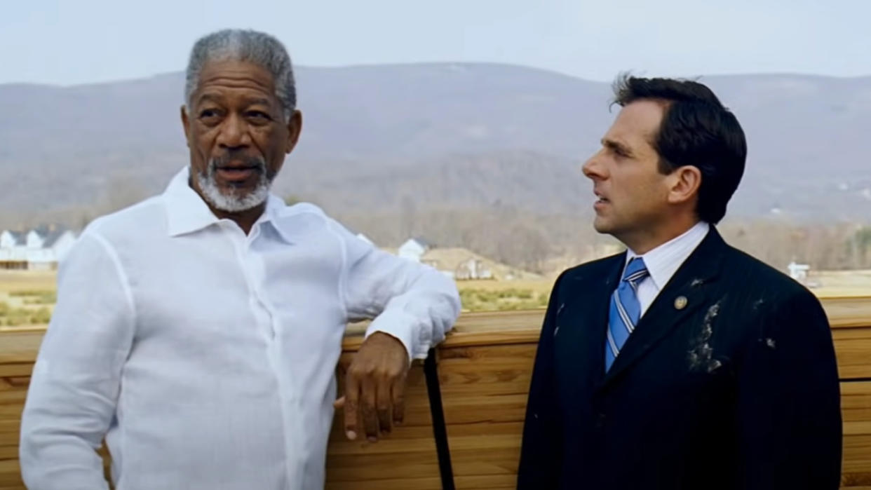  Morgan Freeman stands next to Steve Carell in front of a stack of wood in Evan Almighty. 