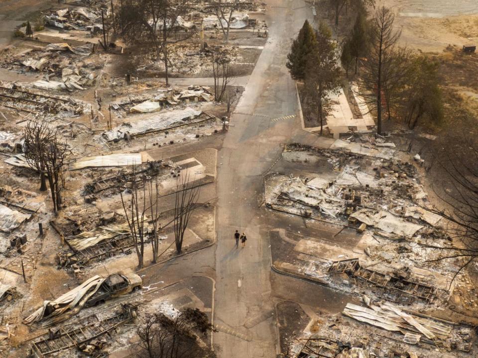 <div class="inline-image__caption"><p>In this aerial view from a drone, people walked through a mobile home park destroyed by fire on September 10, 2020 in Phoenix, Oregon. Hundreds of homes in the town were lost in devastating wildfires that ravaged Oregon, Washington, and California this year.</p></div> <div class="inline-image__credit">David Ryder/Getty</div>