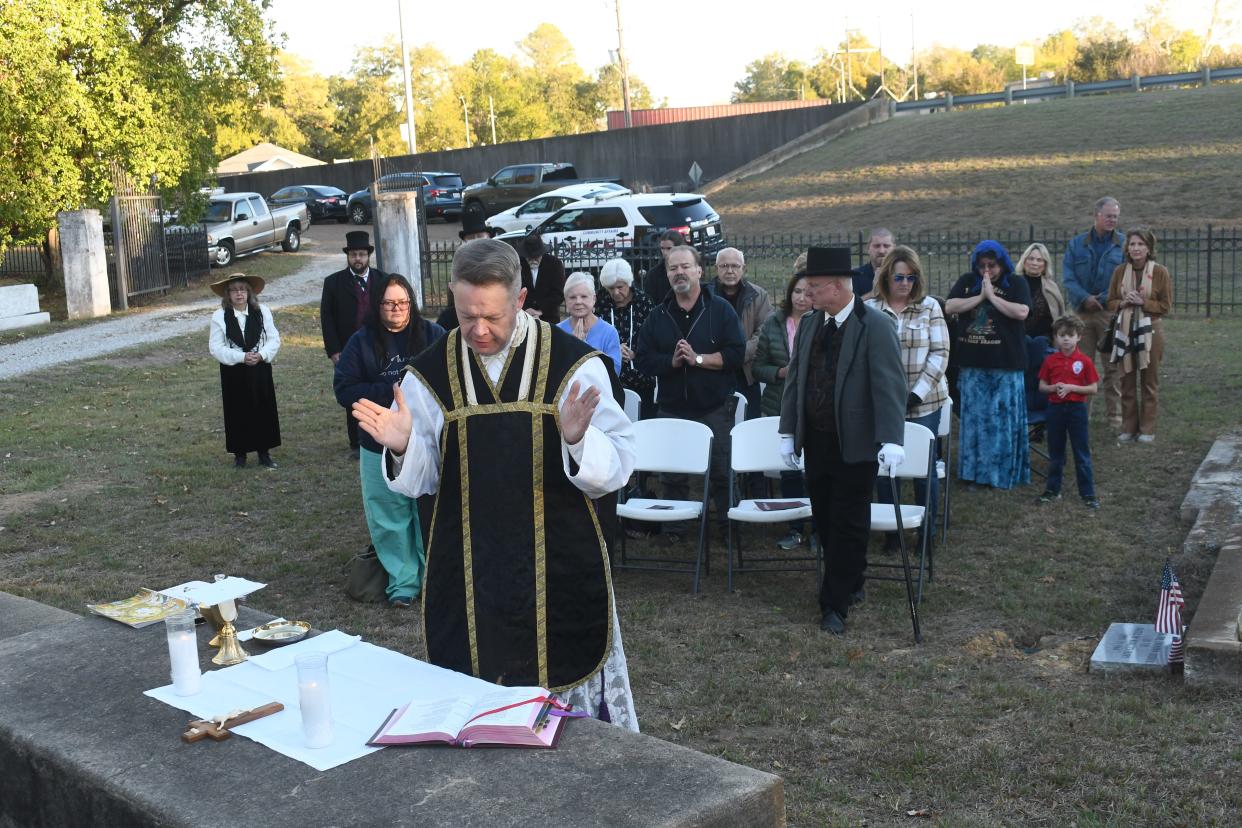 The Historic Rapides Cemetery Preservation Society held an All Souls Day Mass presided over by Father Chad Partain at Old Rapides Cemetery in Pineville. An historic walking tour followed where tour group members learned about some of the historical figures and others buried at the cemetery. The cemetery is located on Hattie Street in Pineville near the Gillis-Long Bridge, known as the Jackson Street Bridge, and dates back over 200 years to when the territory was under Spanish rule. The site is where the house of the first Spanish Commandant Etienne Marafet Layssard of El Rapido Post once stood.