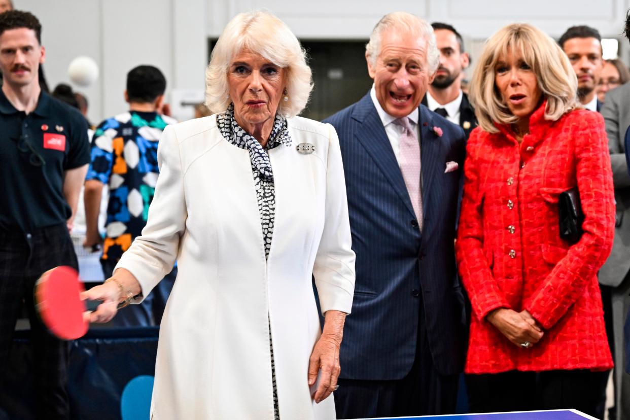 A supportive King Charles appears to be cheering on his wife whilst Brigitte Macron looks shocked, perhaps by the Queen’s skills ... (AP)