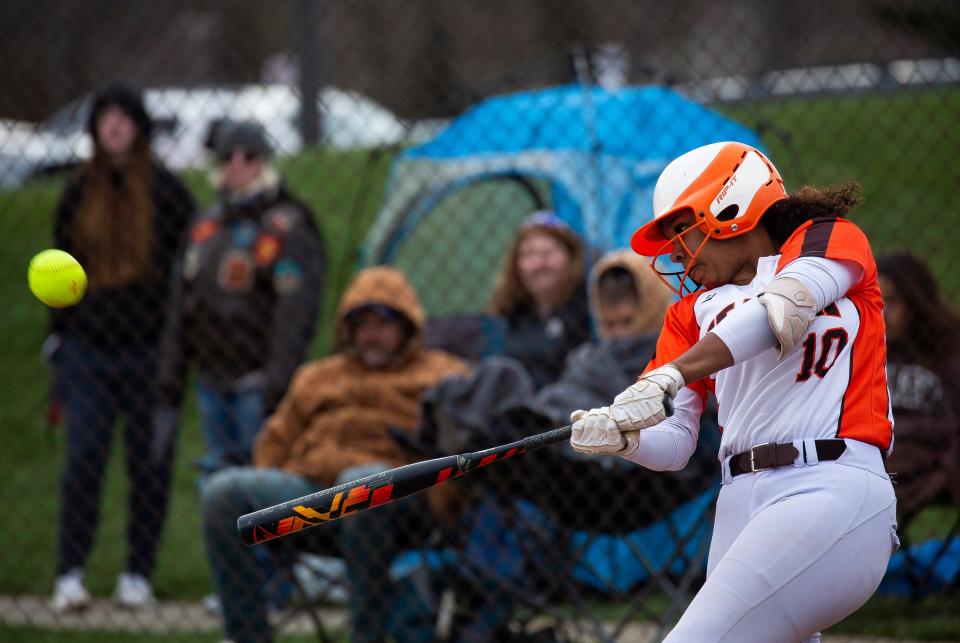 Heath's Renae Cunningham (10) hits a ball into the outfield for an RBI double during the 4-2 season-opening win against visiting Newark.