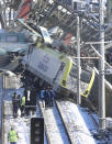 Members of rescue services work at the scene of a train accident in Ankara, Turkey, Thursday, Dec. 13, 2018. A high-speed train hit a railway engine and crashed into a pedestrian overpass at a station in the Turkish capital Ankara on Thursday, killing more than 5 people and injuring more than 40 others, officials and news reports said. (AP Photo/Burhan Ozbilici)