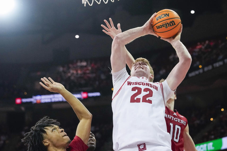 Wisconsin's Steven Crowl (22) shoots against Rutgers' Jamichael Davis, left, and Gavin Griffiths (10) during the second half of an NCAA college basketball game Thursday, March 7, 2024, in Madison, Wis. (AP Photo/Andy Manis)