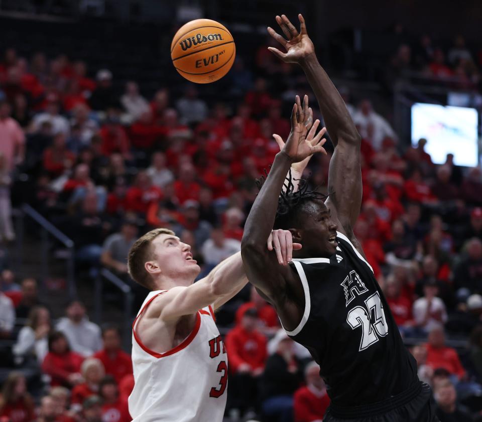 Utah Utes center Lawson Lovering (34) and Hawaii Warriors center Mor Seck (23) compete for the ball at the Delta Center in Salt Lake City on Thursday, Nov. 30, 2023. Utah won 79-66. | Jeffrey D. Allred, Deseret News