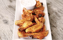 <p>Peri-peri sauce is a traditional African sauce made from spicy African bird's eye chili peppers. For a spicy twist on wings, coat chicken wings in some store-bought peri-peri sauce mixed with apricot preserves for a sticky sweetness and serve them up with an easy yogurt and cilantro dipping sauce.</p> <p><a href="https://www.thedailymeal.com/recipes/peri-peri-chicken-wings?referrer=yahoo&category=beauty_food&include_utm=1&utm_medium=referral&utm_source=yahoo&utm_campaign=feed" rel="nofollow noopener" target="_blank" data-ylk="slk:For the Peri-Peri Chicken Wings with Dipping Sauce recipe, click here.;elm:context_link;itc:0;sec:content-canvas" class="link ">For the Peri-Peri Chicken Wings with Dipping Sauce recipe, click here.</a></p>