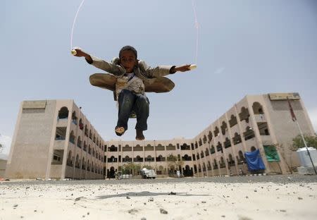 A boy skips at a school in Yemen's capital Sanaa sheltering people after the conflict forced them to flee their areas from the Houthi-controled northern province of Saada August 4, 2015. REUTERS/Khaled Abdullah