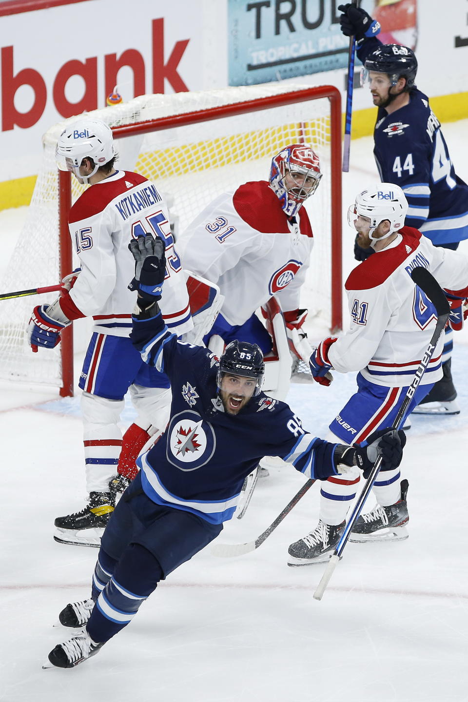 Winnipeg Jets' Mathieu Perreault (85) celebrates a goal by Derek Forbort, not seen, against Montreal Canadiens goaltender Carey Price (31) during the third period of Game 1 of an NHL hockey Stanley Cup second-round playoff series Wednesday, June 2, 2021, in Winnipeg, Manitoba. (John Woods/The Canadian Press via AP)