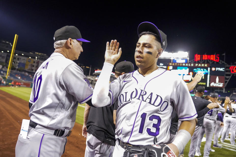 Colorado Rockies' Alan Trejo (13) celebrates with teammates after a baseball game against the Washington Nationals at Nationals Park, Monday, July 24, 2023, in Washington (AP Photo/Alex Brandon)