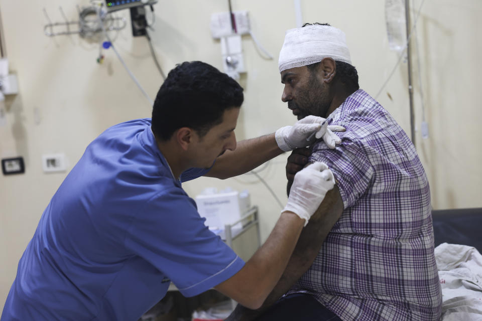 A man injured in the shelling from the Syrian government positions gets treated in a hospital in Idlib, Syria, Friday, Oct. 6, 2023. (AP Photo/Ghaith Alsayed)