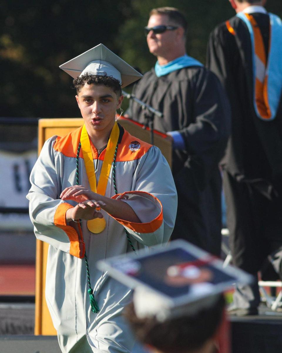 Valedictorian Shawky Bassil waved his hands and the front row on cue tipped over in their chairs. Atascadero held their 102nd commencement ceremony.