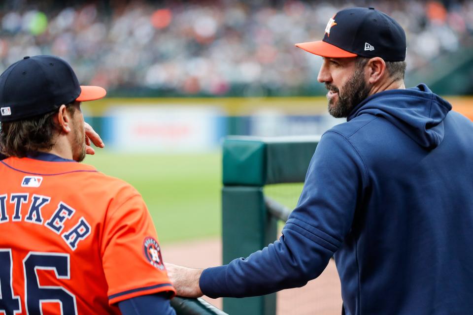 Houston Astros pitcher Justin Verlander (35) talks to hitting coach Troy Snitker (46) in the dugout during the third inning against the Detroit Tigers at Comerica Park in Detroit on Saturday, May 11, 2024.