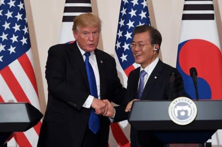 FILE PHOTO: U.S. President Donald Trump and South Korea's President Moon Jae-in shake hands during a joint press conference at the presidential Blue House in Seoul, South Korea, November 7, 2017. REUTERS/Jung Yeon-Je/Pool