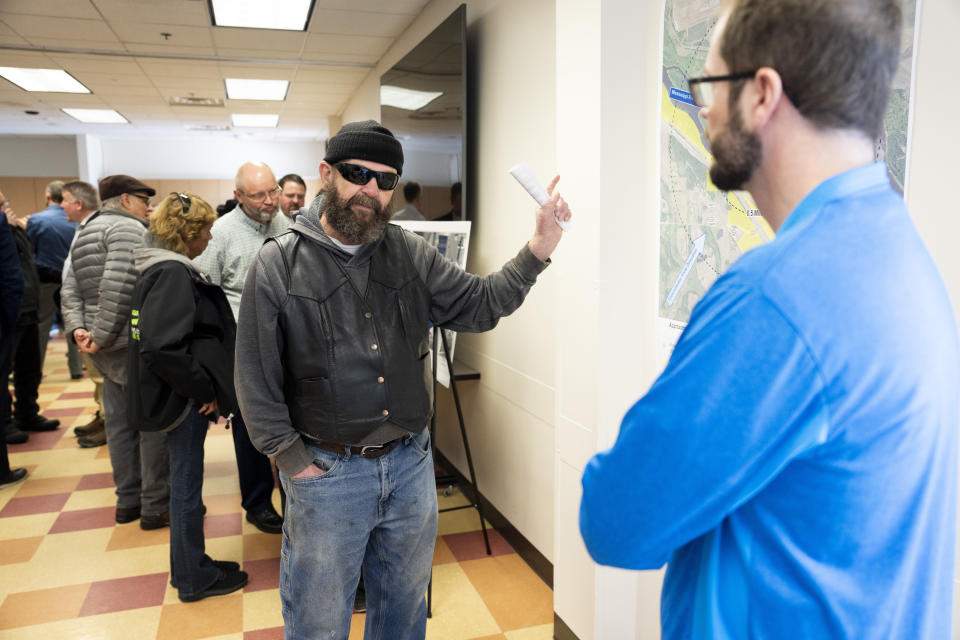 Wally Hauan, who lives along the Mississippi River next to the nuclear power plant, asks questions after his safety and the safety of animals to Trent Farnum of the Minnesota Department of Health during a community meeting in Monticello, Minn., on Friday, March 24, 2023. A leak of what was believed to be hundreds of gallons of water containing tritium was discovered this week from a temporary fix at the Monticello Nuclear Generating Plant, where 400,000 gallons (1.5 million liters) of water with tritium leaked in November, Xcel Energy said in a statement Thursday. (Renee Jones Schneider /Star Tribune via AP)