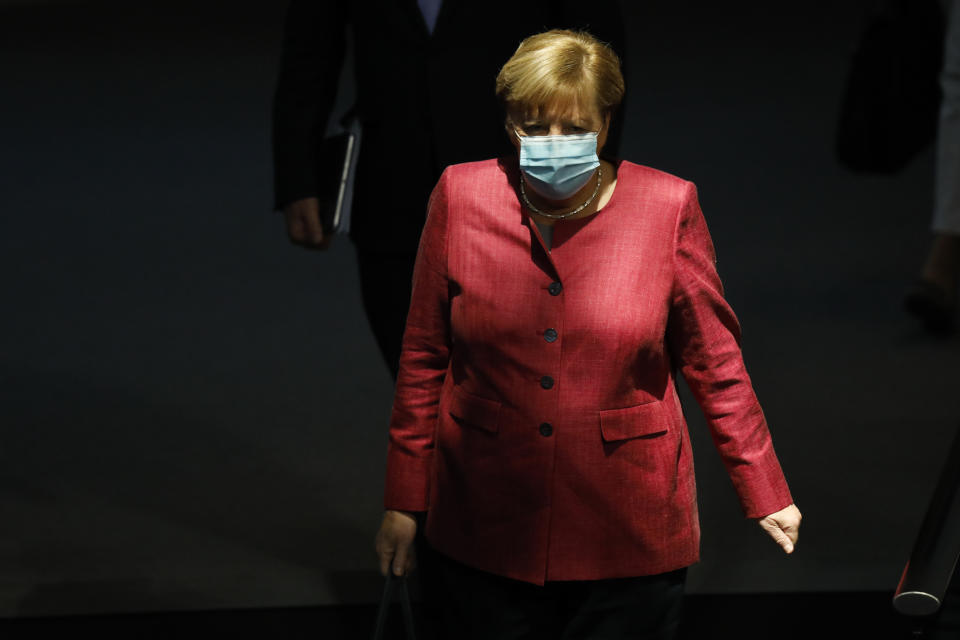 German Chancellor Angela Merkel arrives for a debate about her policy as part of Germany's budget 2021 debate at the parliament Bundestag in Berlin, Germany, Wednesday, Sept. 30, 2020. (AP Photo/Markus Schreiber)