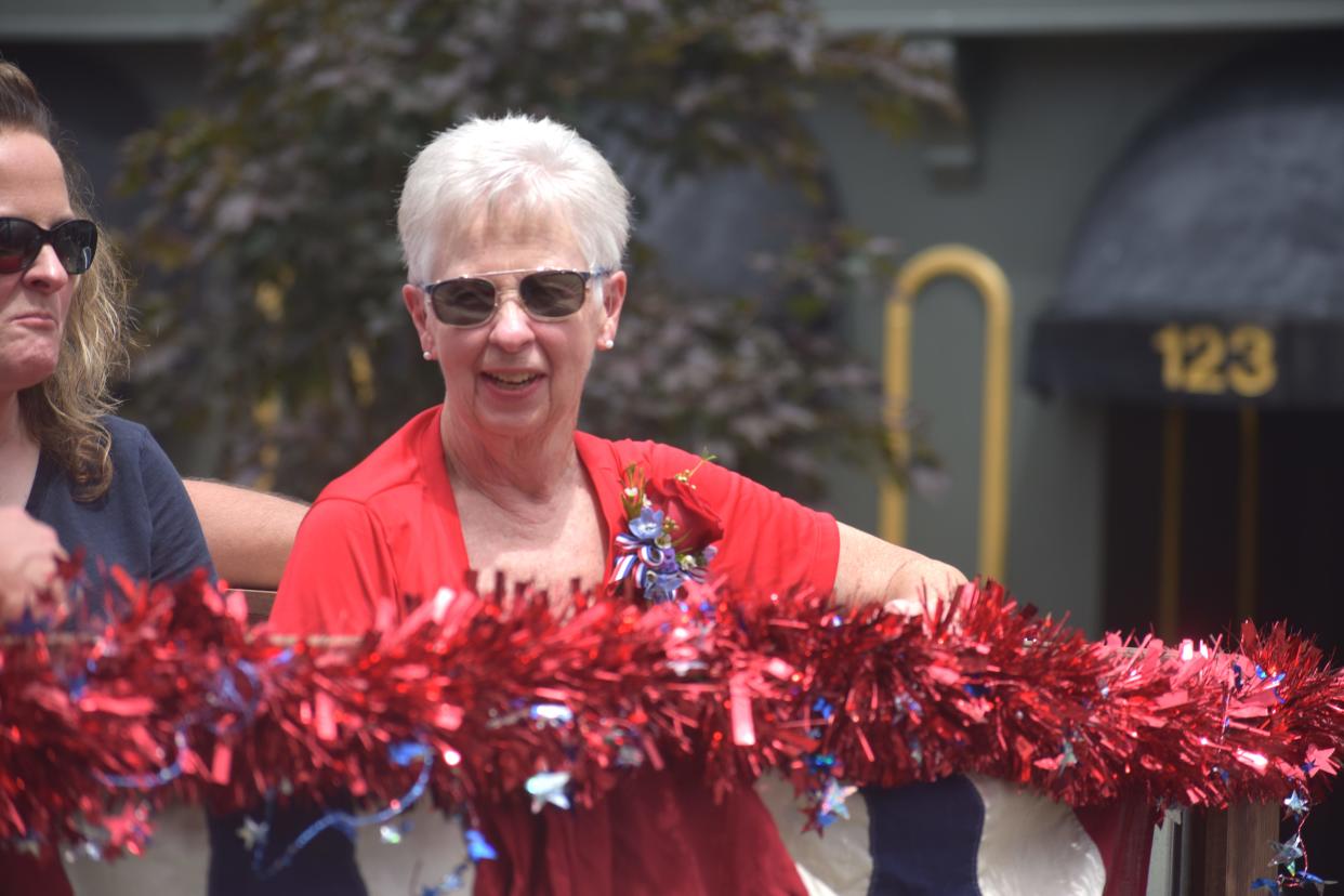 Marty Chrisman, a longtime volunteer with the Lenawee County Fair, rides in the Lenawee County Fair parade Sunday, July 24, through downtown Adrian, as its grand marshal. Chrisman was nominated for the parade grand marshal because of her involvement with the fair, her years of volunteering and because she is an “unsung hero” of the fair, according to the Lenawee County Fair parade committee.