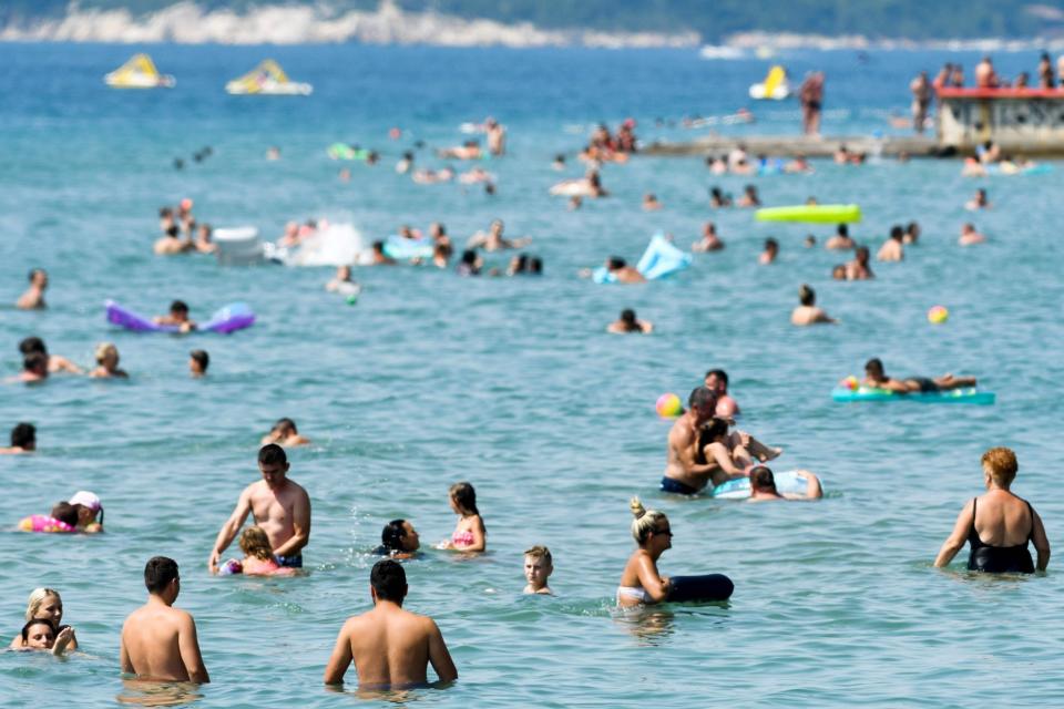 Crowds of people, mostly foreign tourists, enjoy the beach, sunbath and swim in the sea on August 13, 2020, in Crikvenica on the northern Adriatic coast (AFP via Getty Images)