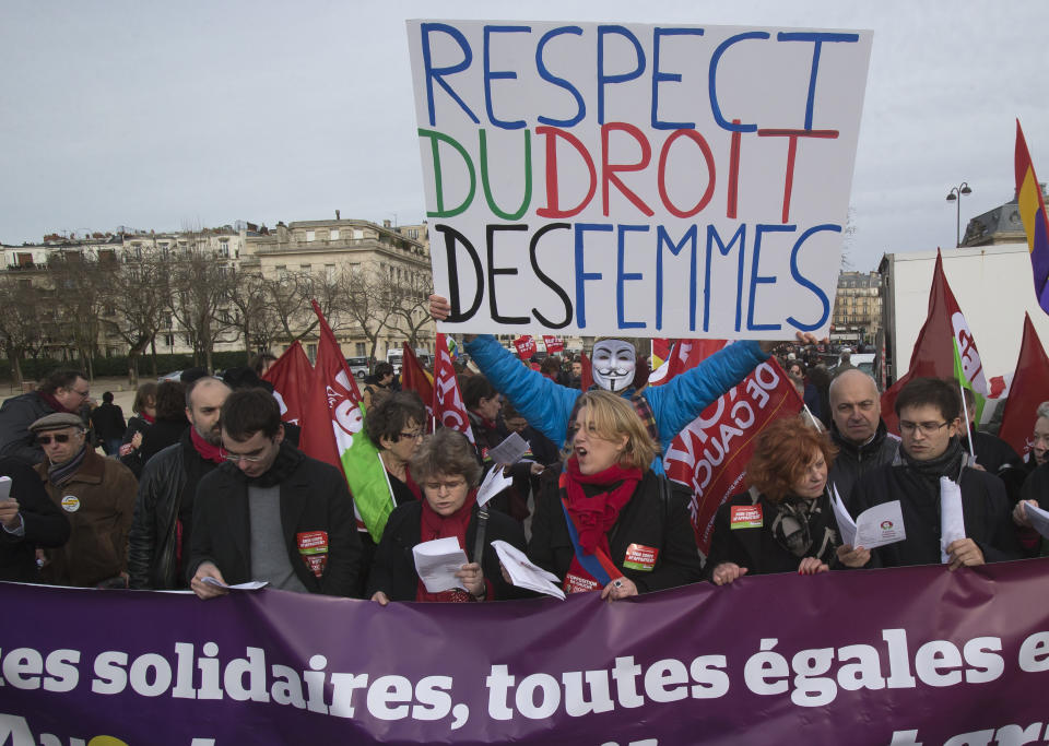 Demonstrators protest against the new abortion law in Spain, during a rally in Paris, Saturday Feb. 1, 2014, after Spain's conservative government approved tight restrictions on abortions. Placard. Placard reads, "respect the women rights".(AP Photo/Michel Euler)