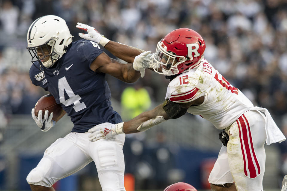 Penn State running back Journey Brown (4) stiff arms Rutgers defensive back Christian Izien (12) in the first quarter of an NCAA college football game in State College, Pa., on Saturday, Nov. 30, 2019. (AP Photo/Barry Reeger)