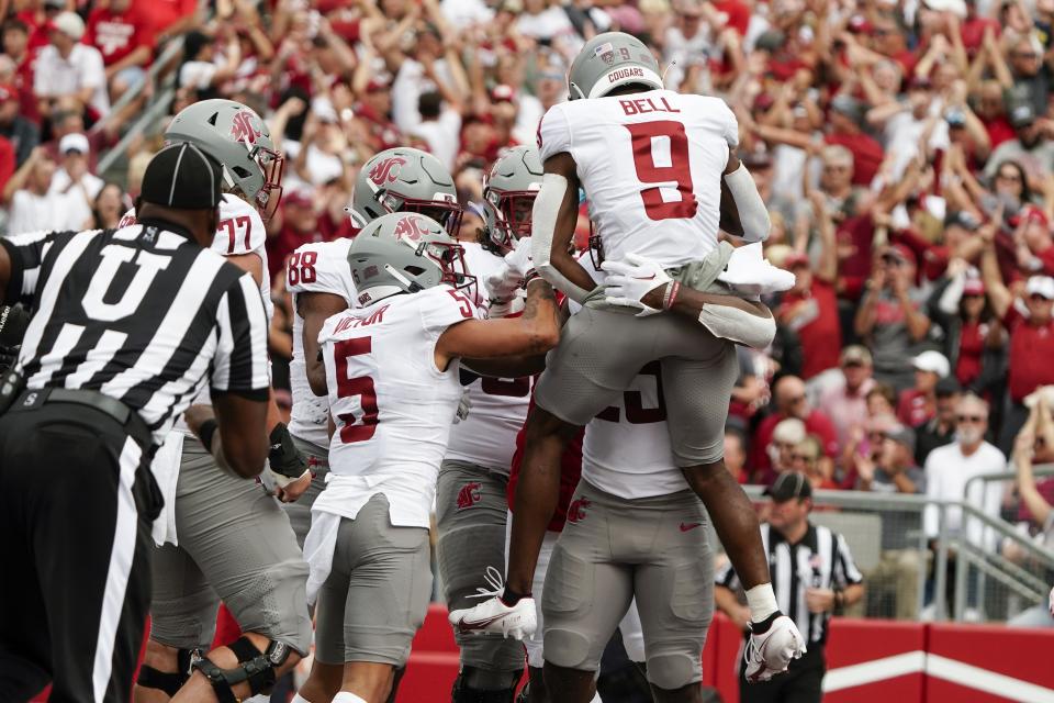 Washington State's Nakia Watson (25) is congratulated after running for a touchdown during the first half of an NCAA college football game Saturday, Sept. 10, 2022, in Madison, Wis. (AP Photo/Morry Gash)