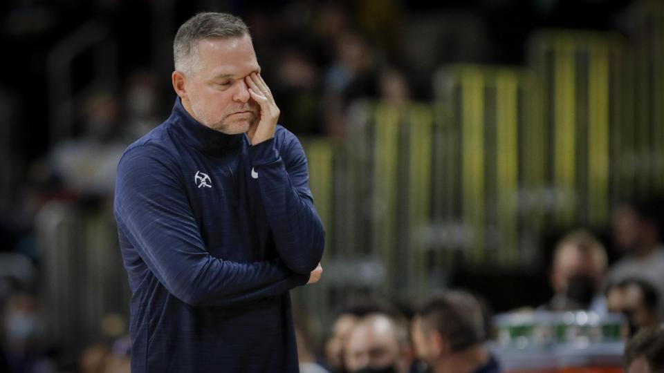 Denver Nuggets coach Michael Malone rubs his eye in the first quarter of a preseason NBA basketball game against the Minnesota Timberwolves in Denver, Friday, Oct. 8, 2021. (AP Photo/Joe Mahoney)