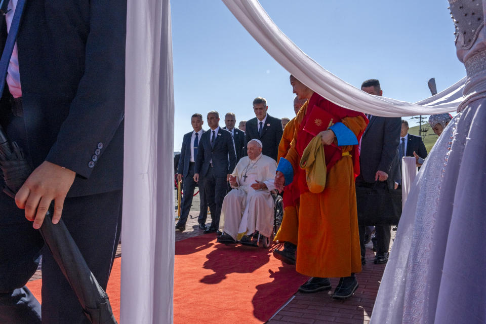 Pope Francis, center, arrives at a meeting with religious leaders at the Hun Theatre in the Sky Resort compound some 15 kilometers south of the Mongolian capital Ulaanbaatar, Sunday, Sept. 3, 2023. Pope Francis has praised Mongolia’s tradition of religious freedom dating to the times of founder Genghis Khan during the first-ever papal visit to the Asian nation.(AP Photo/Louise Delmotte)