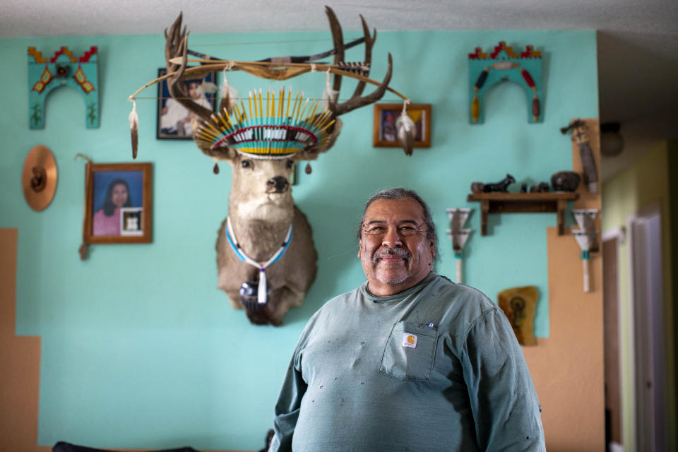 Gilbert Naranjo poses for a photo at his home on Santa Clara Pueblo in northern New Mexico, Monday, Aug. 22, 2022. “Fields just aren’t producing like they used to,” says Naranjo, who's in charge of plowing farmers' fields. He says some people now buy starter plants because it can be difficult to get seeds to germinate. (AP Photo/Andres Leighton)