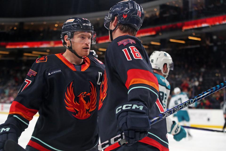 Coachella Valley Firebirds Max McCormick (17), left, and Kole Lind (16) during the game against the San Jose Barracuda at Acrisure Arena in Palm Desert, Calif., on Monday, April 3, 2023. Firebirds pulled out a 4-3 shootout win to secure a top spot in the Pacific Division. 
